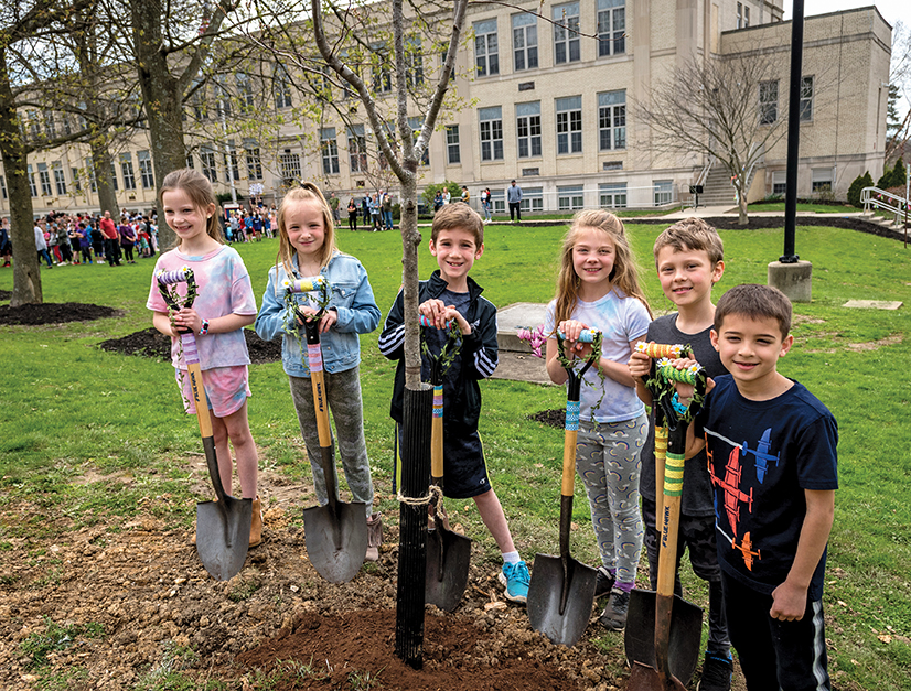 Students planting a tree at Markham elementary school for Arbor Day