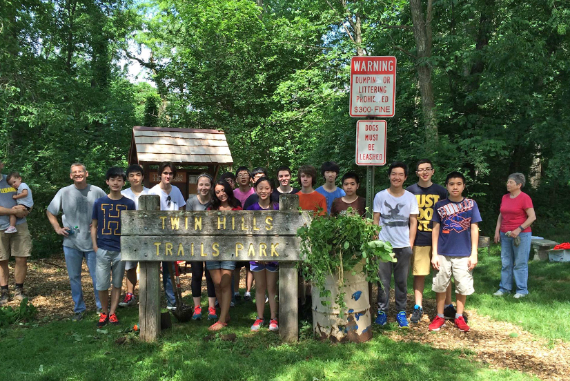 A group of volunteers behind the Twin Hills Trails Park sign